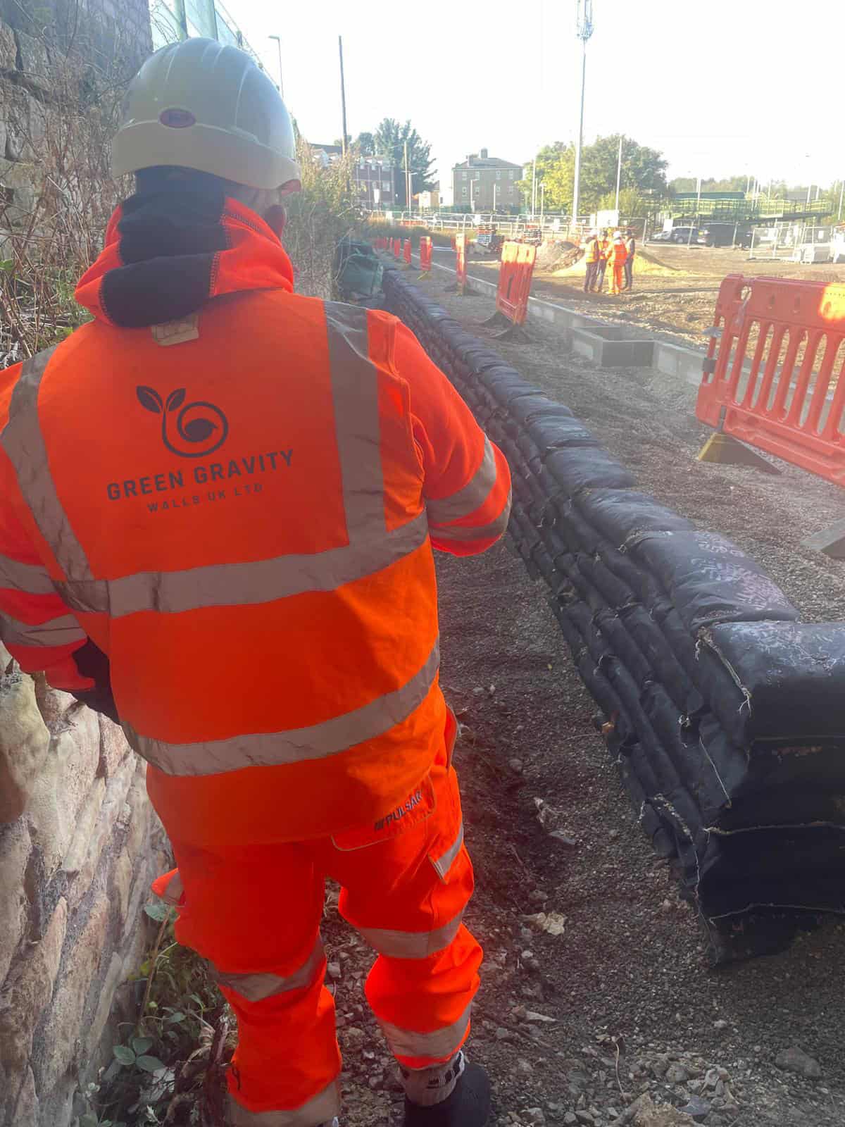 ECO-MSE retaining wall supporting Normanton Station Car Park with vehicle barrier installed behind