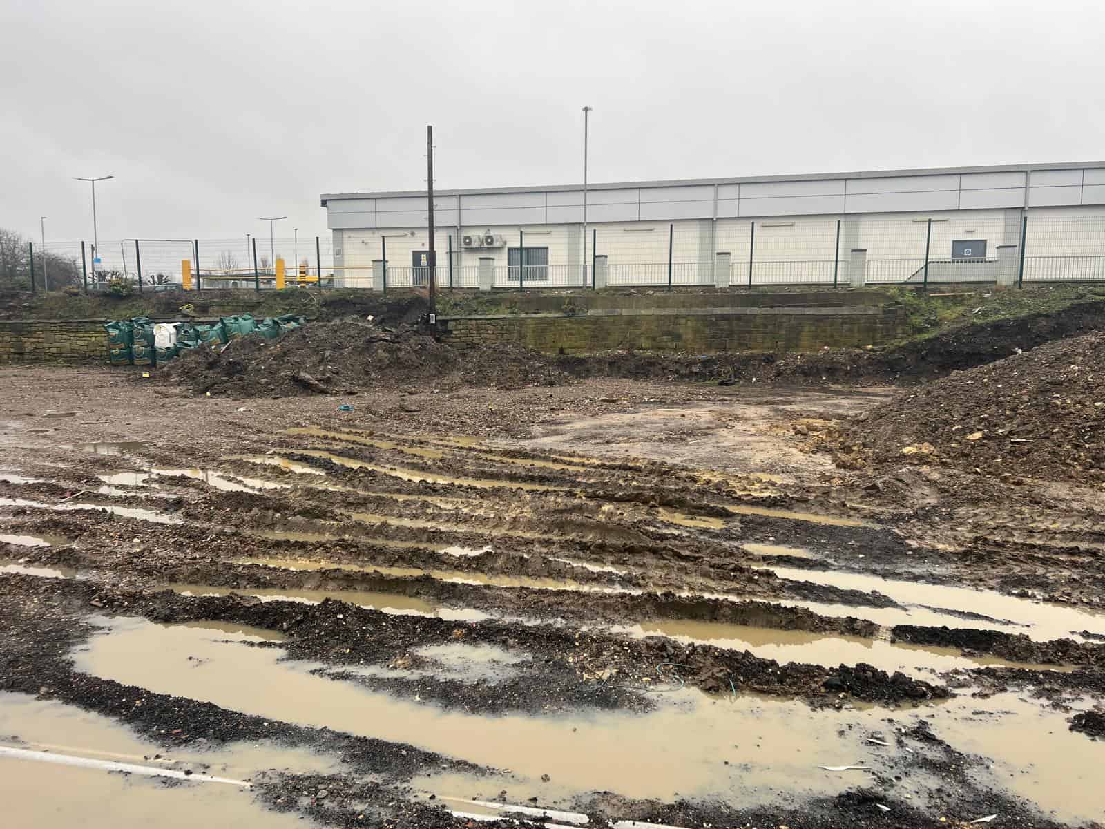 Completed car park boundary at Normanton Station with retaining wall and vehicle barrier